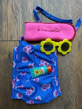 American Girl Blue Floral Swimsuit with Yellow Flower Sunglasses and sunscreen